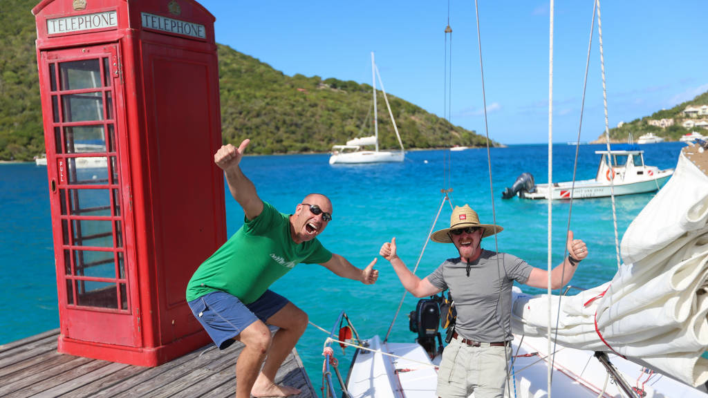 People posing on a dock amongst boats in the BVI