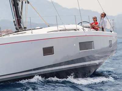 Man and woman sailing Sunsail 524